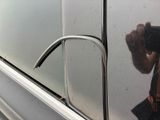 reflection of a man taking a picture of himself in a car mirror