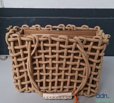 un sac tissé muni d'une anse, posé sur une table