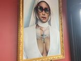 a picture of a woman with sunglasses on a red wall
