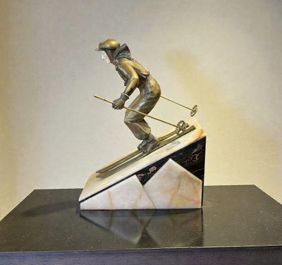 statue of a skier on a marble base on a black table