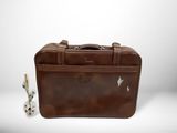 brown leather briefcase with dice and dice in front of it
