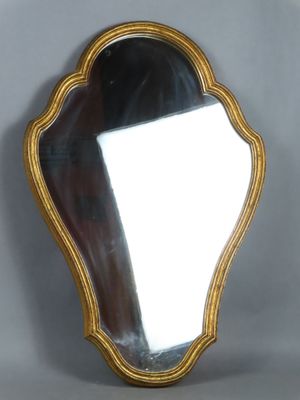 an image of a mirror with a gold frame on a gray background