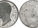 a close up of a silver coin with a man ' s face on it