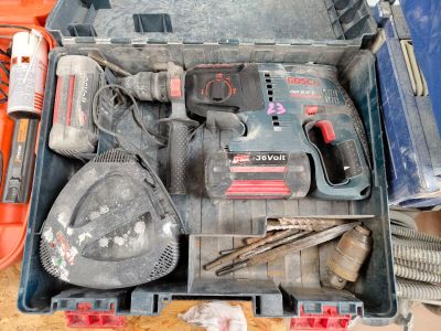 a tool box with tools in it sitting on the ground
