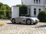 a silver sports car parked in front of a white house