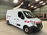 a white van parked in a warehouse with a crane on top of it