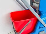 a blue and red mop and bucket on a blue cart