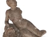 an image of a statue of a woman sitting on a rock