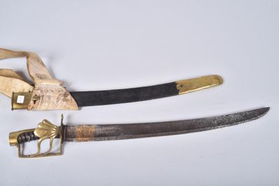 pair of old and worn swords on a white surface
