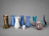 five different vases sitting next to each other on a gray surface