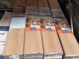 several stacks of wood planks stacked on top of each other in a warehouse