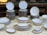 une table sur laquelle se trouvent beaucoup d'assiettes et de bols