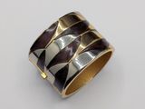 a close up of a silver and gold ring on a white surface