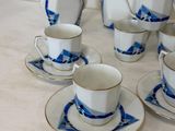 a lot of cups and saucers sitting on a table