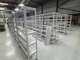 many shelves in a warehouse with a lot of empty ones
