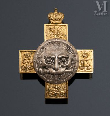 a gold cross with an image of a lion on it