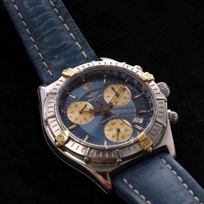 a close up of a watch on a black surface