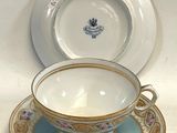 a tea cup and saucer sitting on a table