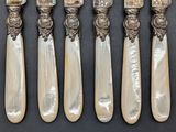 five silverware spoons with mother of pearl and mother of pearl on them