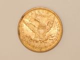 an image of a gold coin on a white surface