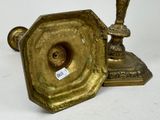 a gold candle holder with a sticker on it