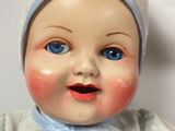 a baby doll that is wearing a blue outfit and a hat
