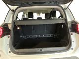 the back of a white car with its trunk open and the back seats down