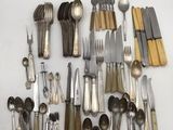 many different types of silverware on the table
