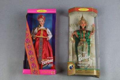 two dolls of different colors are in a box on a table