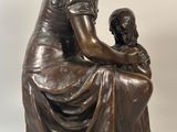 bronze statue of a woman and child sitting on a marble base
