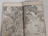 an open book with a drawing of a house on it