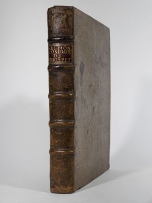 an old book sitting on top of a white surface