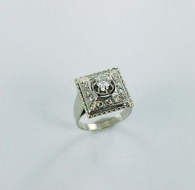 a close up of a silver ring on a white surface