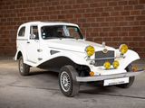 a white car that is parked in front of a brick wall