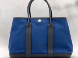 a blue and black tote bag on a white background