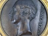 a close up of a bronze medallion of a man ' s head
