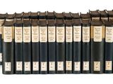 six black and white books are stacked on top of each other