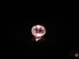 gros plan d'un diamant rose sur une surface noire