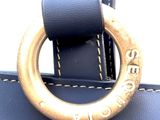 a close up of a blue bag with a ring on it