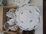 many plates and cups in a box on the table