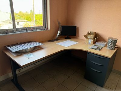 a computer desk with a keyboard and a monitor on it