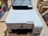 several printers sitting on top of a box in a store