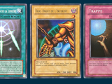 three cards with different designs on them on a blue background