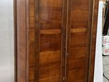 an image of a wooden cabinet with a door on top of it