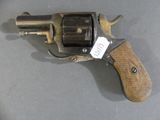 an old revolver with a tag on it sitting on a table