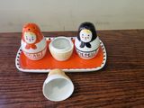 a small tray with a couple of salt and pepper shakers on it