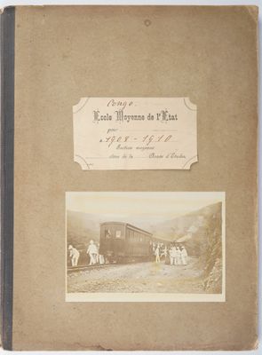 an old photo of a couple of people standing next to a train