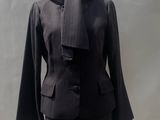 a mannequin with a black jacket on a mannequin stand