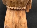 wooden statue of a man with a hat on top of his head