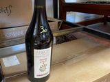 a bottle of wine sitting on top of a box on the floor